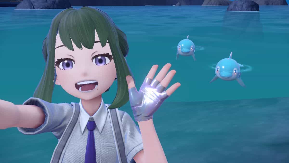 Two Finizen swim in the ocean behind the player in Pokémon Scarlet & Violet