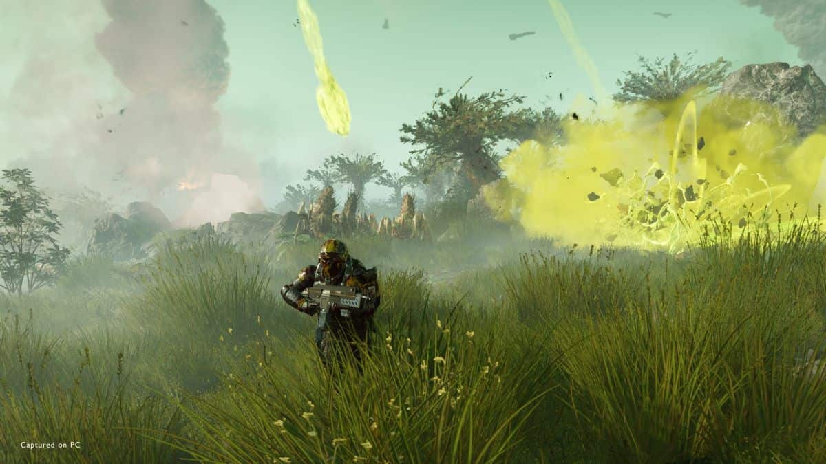 A soldier heads through a grassy area away from explosives in Helldivers 2