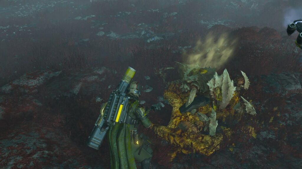 Helldivers 2 image of the player stading above some dead Terminids