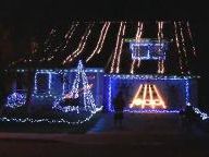 Guitar Hero Played On Side of House in Christmas Lights