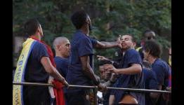 Slap happy: Alex Song and Gerard Pique in fight on open-top bus