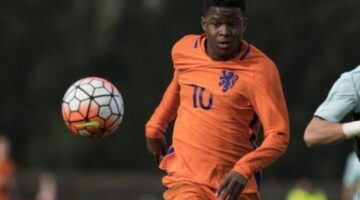 Done deal: Forward poses with Chelsea shirt at Stamford Bridge